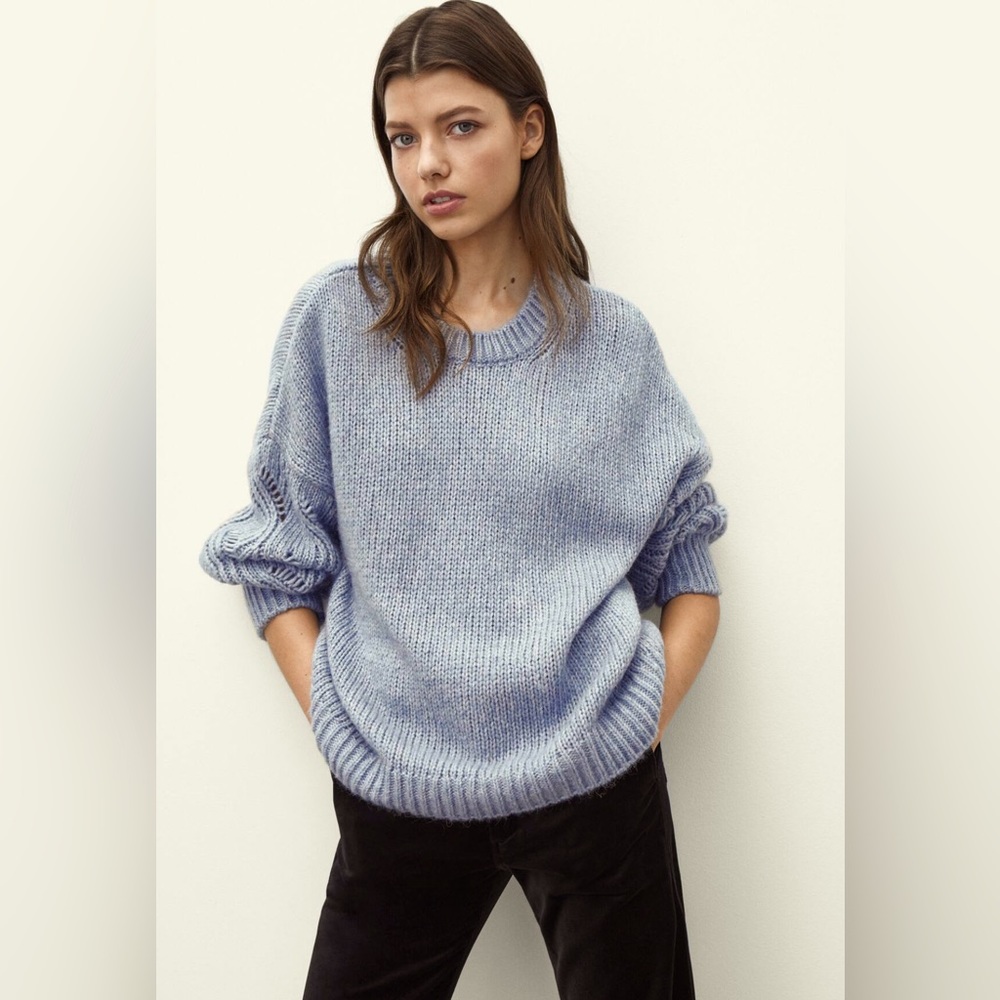 Knit sweater with open knit sleeves
